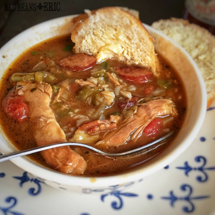 Bowl of chicken and sausage gumbo with a warm French bread